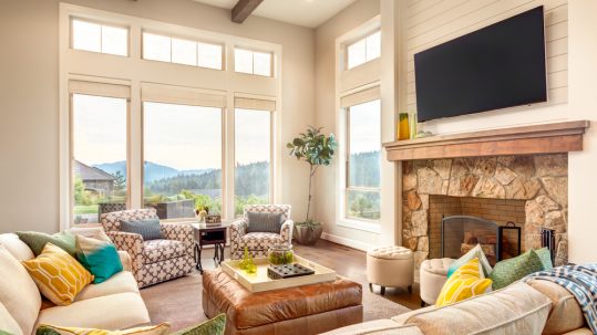 Large and spacious living room with big windows and mountain views